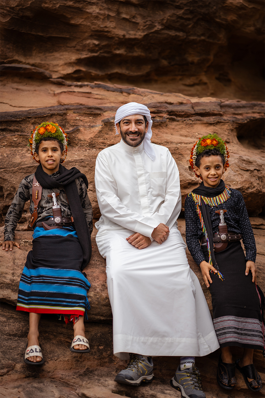 Mohammed Kazim, founder of Tamashee and Tamashee Experiences, sitting with two young boys in traditional Saudi attire in Abha, reflecting cultural storytelling and regional connection.